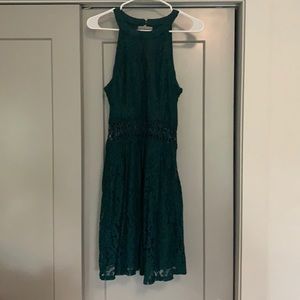 Green halter dress with lace detail.